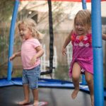 Little girls jumping on trampoline