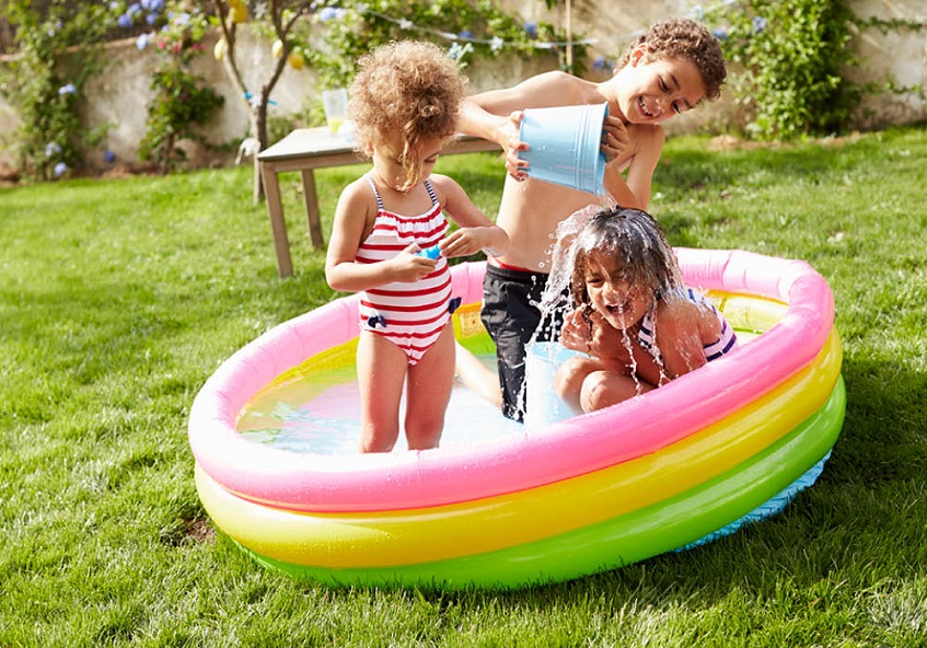 kids playing in a backyard pool