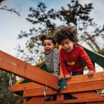 children playing on a wooden house