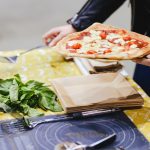 man is making pizza outdoor