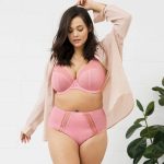 woman wearing plus size lingerie in pink colour