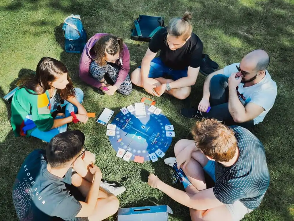 Friends playing board game on picnic