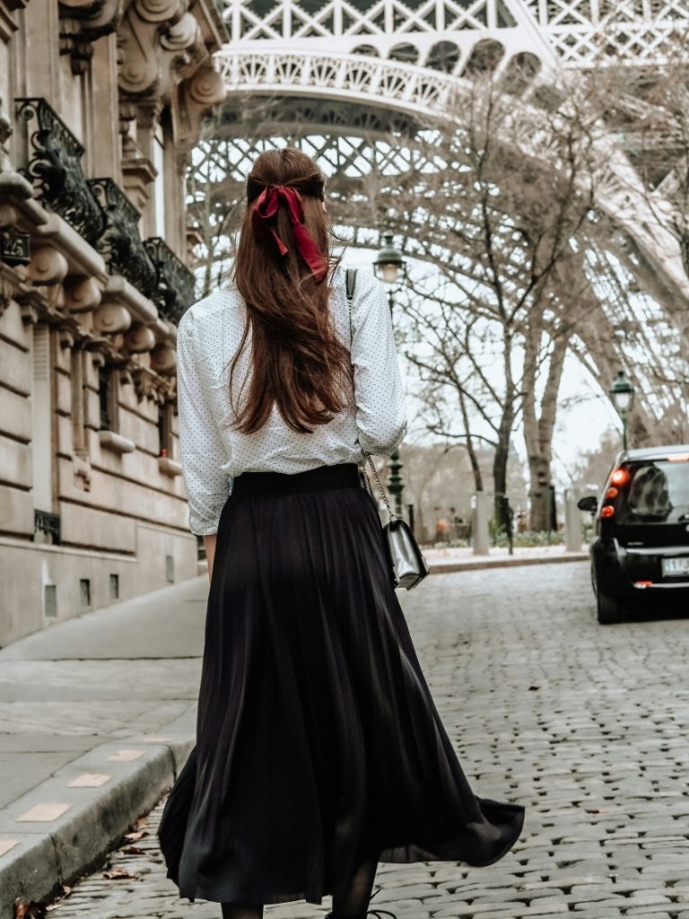 woman on the street wearing black long skirt and white top