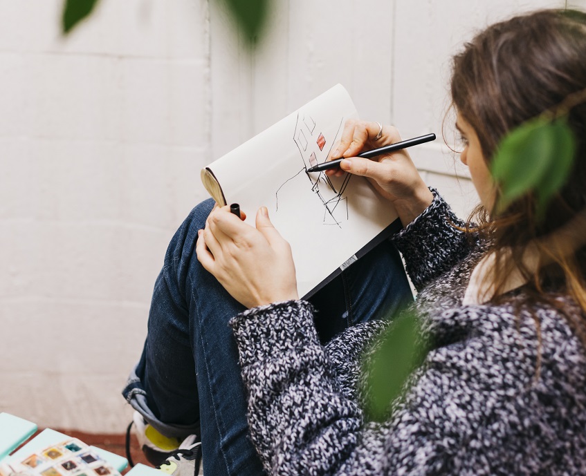 woman drawing on a sketchpad