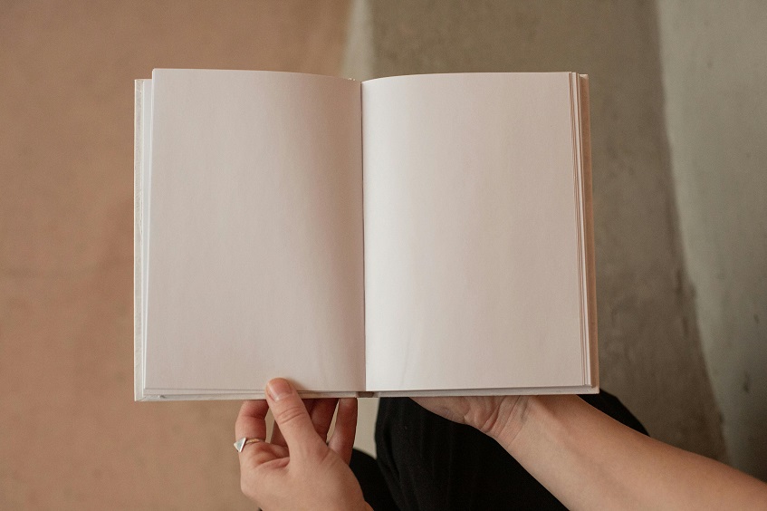 woman holding a blank sketchbook