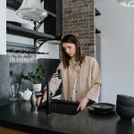 woman in the kitchen cleaning the sink