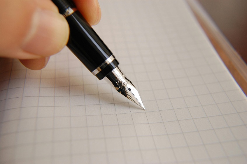 close up of a dip calligraphy pen writing