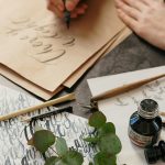 woman writing with a calligraphy pen