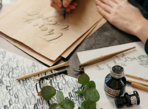 woman writing with a calligraphy pen