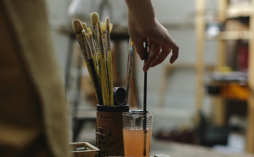 artist using paint brushes
